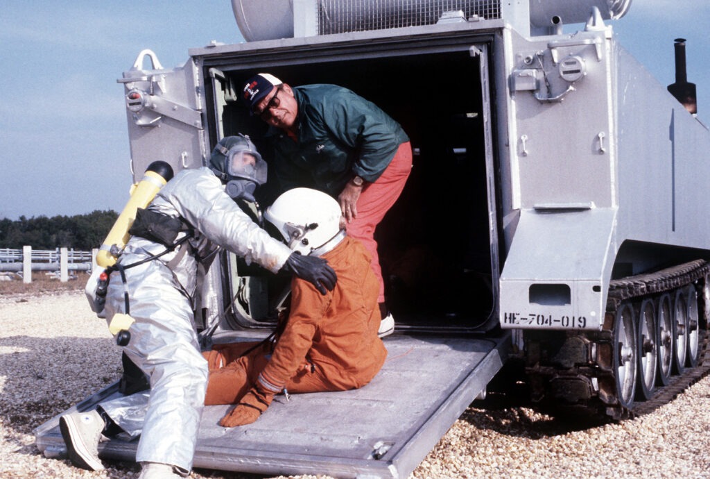 Two pararescuemen remove an astronaut mannequin from the XM-1 astronaut recovery tank and place it on a stretcher during a space shuttle rescue exercise.  The exercise is one of several planned to optimize rescue and recovery operations for the space shuttle Columbia.